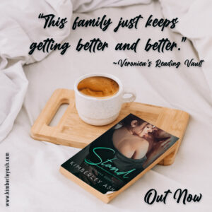 Reviewer Quote: This family just keeps getting better and better" above a wooden tray with a cup of coffee and a worn paperback of Stand.
